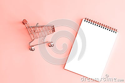 Isolated notepad with mini shopping carts. Stock Photo