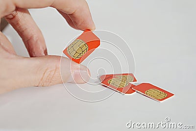 Isolated photo of male hand holding red SIM card Stock Photo
