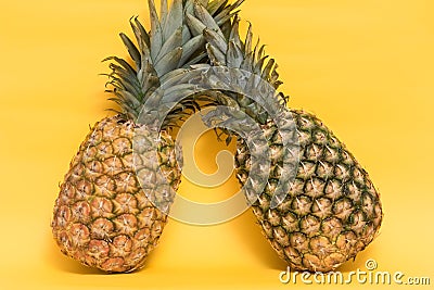 Isolated pineapples on a yellow background. Stock Photo