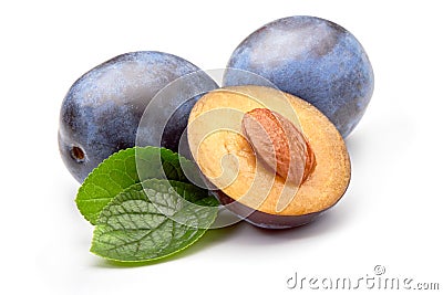 Isolated plums. One and a half of blue plum fruit with leaves isolated on white background Stock Photo