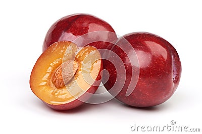 Isolated plums. One and a half of red plum fruit with leaves isolated on white background Stock Photo