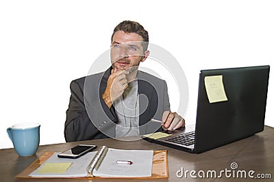 Isolated portrait of young successful and attractive businessman working at office computer desk satisfied and relaxed in Stock Photo