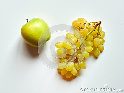Isolated set of a green apple with a bunch of sweet seedless grapes in studio with white background Stock Photo