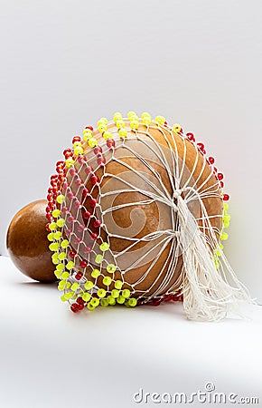Isolated Shekere or Sekere, Close up of the bottom and ponytail, a Nigeria, Yoruba percussion musical instrument. Stock Photo