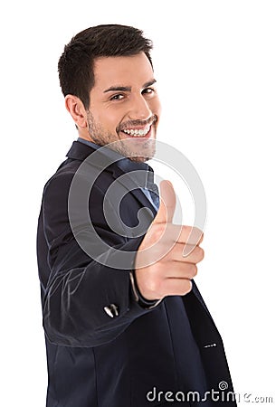 Isolated smiling businessman making thumbs up gesture. Stock Photo