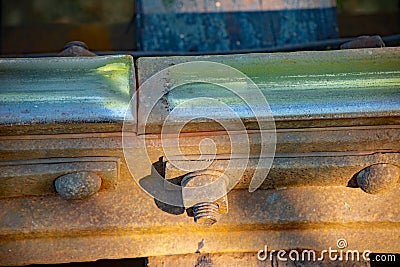 Isolated view of bolts holding rails on vintage railway trestle Stock Photo