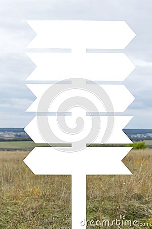 Isolated on white pole with empty signposts in the field. Space for text. Vertical Stock Photo