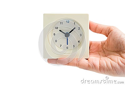 Isolated woman hand hold white alarm square clock on white background Stock Photo