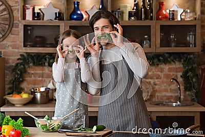 Isolation With Fun. Happy Father And Little Daughter Fooling In Kitchen Stock Photo