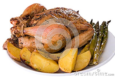 Isoloated roasted whole chicken on a plate Stock Photo