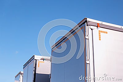 Isotherm cargo semi-trailers on a background of blue sky. The concept of the capacity and volume of a modern semi Stock Photo