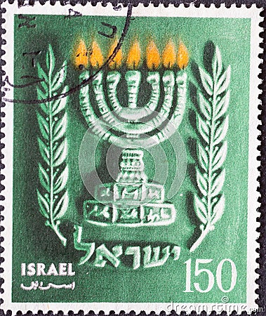 ISRAEL - CIRCA 1990: a postage stamp printed in Israel showing Hanukkah, with Israel`s state emblem, the 7-armed temple candlesti Editorial Stock Photo