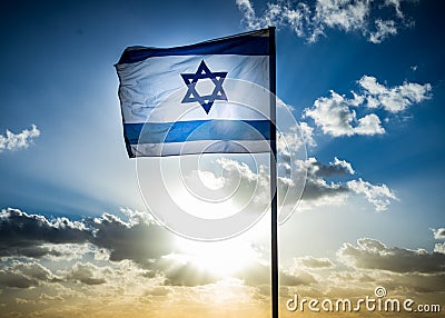 Israel flag waving cloudy sky background sunset Stock Photo