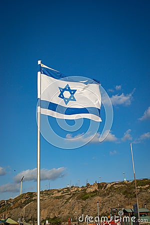 Israel flag waving cloudy sky background sunset Editorial Stock Photo