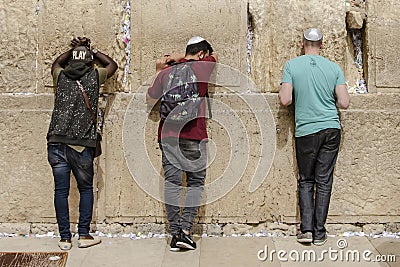 ISRAEL. JERUSALEM. 12.05.2018 - Three religious jews pray in The western wall , An Important Jewish religious site located in the Editorial Stock Photo