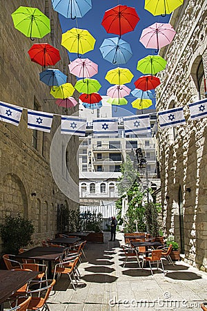 Israel-Jerusalem 12-05-2019 View of a terrace situated between the tall buildings, decorated with umbrellas and Israeli flags in t Editorial Stock Photo