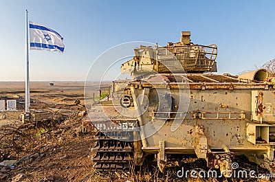 Israeli flag flying beside an Israeli tank from the Yom Kippur War at Tel Saki on the Golan Heights Stock Photo