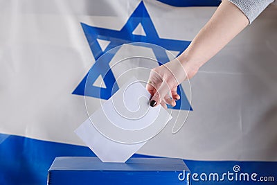 Israeli woman votes at a polling station on election day. Stock Photo