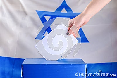 Israeli Young woman putting a ballot in a ballot box on election day Stock Photo