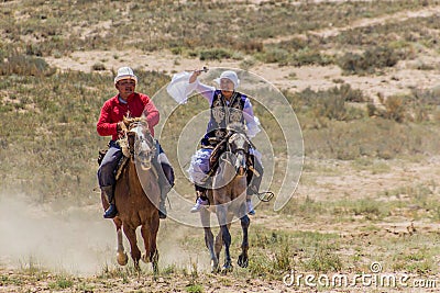 ISSYK KUL, KYRGYZSTAN - JULY 15, 2018: Performance of kyz kuuma girl chasing , equestrian traditional sport at the Editorial Stock Photo
