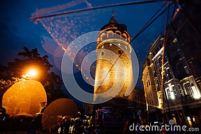 Istanbul, Galata Tower. View on architecture through a transparent umbrella in the rain. Nice bokeh. Tourism Editorial Stock Photo