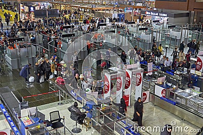 Istanbul Sabiha Gokcen Airport - January 2020. Queue of people walking through metal detector frame Editorial Stock Photo