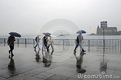 Istanbul steamboat pier people walking in the rain. Editorial Stock Photo