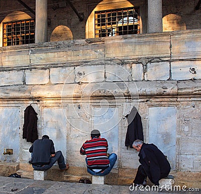 Turkey, Istanbul, Muslim men perform ablutions outside mosque Editorial Stock Photo