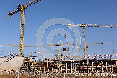 Undefined workers working on construction Editorial Stock Photo