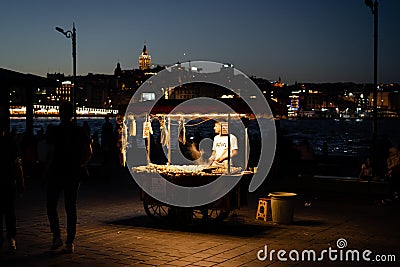 Man with vendor cart selling cooked corn on the shores of Bosphorus Editorial Stock Photo