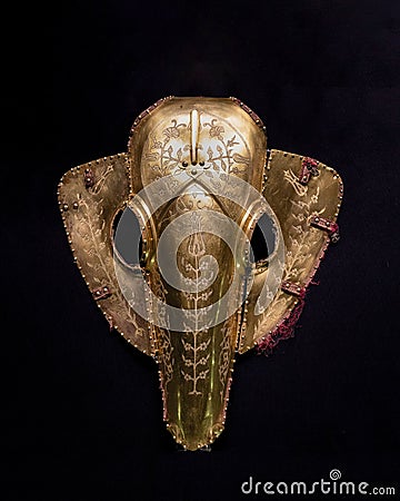 Istanbul, Turkey - June 18 2022: Antique horse helmet made of gold to protect the horse`s face in battle Editorial Stock Photo
