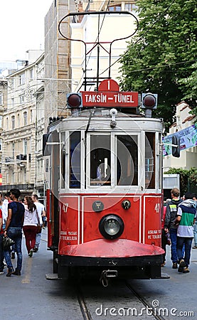 ISTANBUL,TURKEY-JUNE 7:A historic red tram in front of the Galatasaray High School at the southern end of istiklal Avenue.June 7,2 Editorial Stock Photo