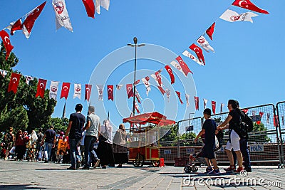 Kadikoy city center with a crowd of people and Turkish flags hanging on the ropes Editorial Stock Photo