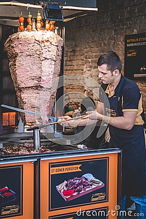 Istanbul, Turkey - June 6, 2020. Turkish man is preparing Doner Kebab in Kebab Bar. Editorial Stock Photo