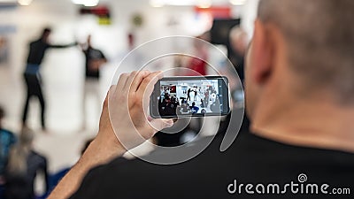 Student makes mobile phone video with Kapap instructor Avi Nardia Editorial Stock Photo