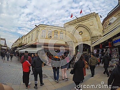 Istanbul, Turkey - March 8, 2019: People shopping in the Grand Bazar, handmade pillows, bags and carpets are on the wall for sale Editorial Stock Photo