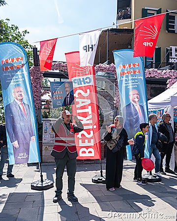 Man waving big poster of Kemal Kilicdaroglu photo in front of Republican Peoples Party kiosk, Ortakoy, Istanbul, Turkey Editorial Stock Photo