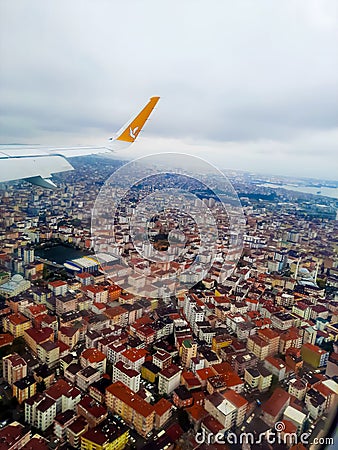 A Pegasus airline plane comes in for landing in Istanbul among clouds at altitude close up of its Editorial Stock Photo