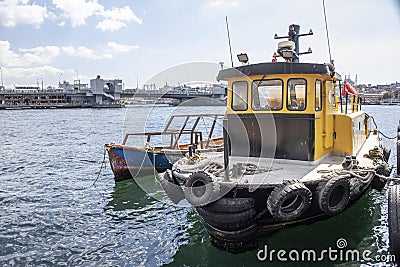 Istanbul, Turkey - September-28,2019: Closeup of fishing boat on hand. Galata bridge and sky in background Editorial Stock Photo