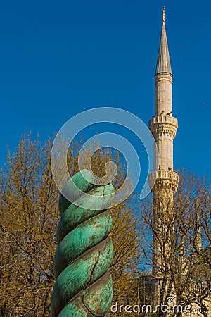 ISTANBUL, TURKEY: Snake Column and Blue Mosque in Sultanahmet Square Stock Photo