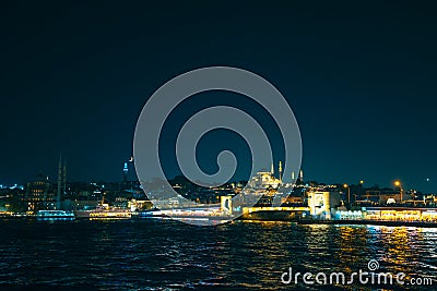 Istanbul view at night. Crescent moon and Suleymaniye Mosque with Galata Bridge Editorial Stock Photo