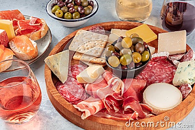 Italian antipasti or Spanish tapas with wine. Charcuterie platter Stock Photo