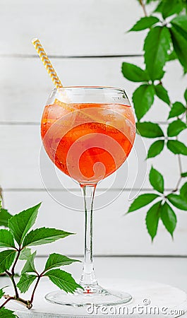 Italian aperol spritz cocktail in a wine glass on white wooden background Stock Photo