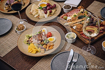 Italian appetizer - various types of ham, cheese and grissini Stock Photo