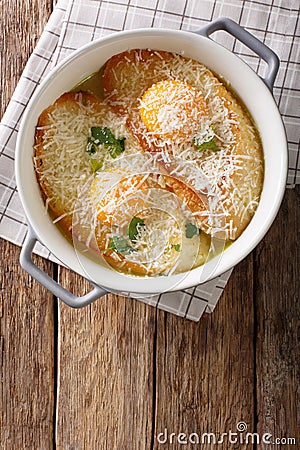 Italian baked bread soup alla Pawese close-up. Vertical top view Stock Photo