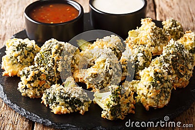 Italian baked broccoli appetizer with parmesan served with sauces. horizontal Stock Photo