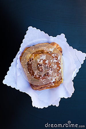 Italian breakfast. top view to fresh crunchy croissant or cornetto with glaze and chocolate on white napkins on black Stock Photo