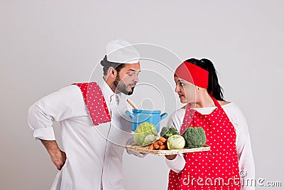 Italian Chief cook and Handsome Cooky with Tray of Vegetables Stock Photo