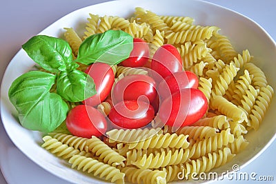 Italian cuisine, pasta with tomato and basil. Stock Photo