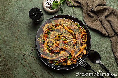 Italian dinner with cuttlefish stew with peas and tomatoes or seppie con piselli. Stock Photo